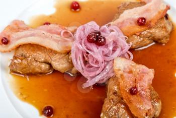 Royalty Free Photo of a Roast Pork Meat With Bacon, Onion and Cranberries