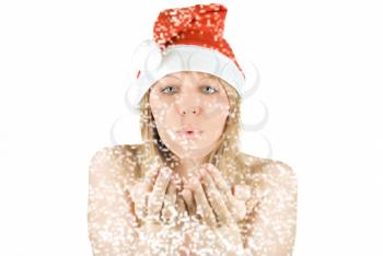 Royalty Free Photo of a Woman Wearing a Santa Hat Blowing Snow