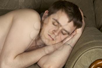 Royalty Free Photo of a Man Sleeping on a Couch