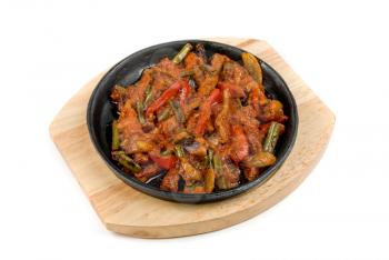 Roasted meat with vegetables at pan on a white background