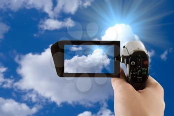 Royalty Free Photo of a Person Videotaping the Sky