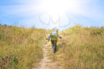 Royalty Free Photo of a Hiker With a Rucksack Up-Hill