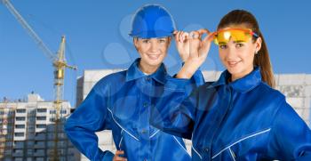 Royalty Free Photo of Female Builders on a Building Background