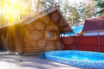 Royalty Free Photo of a Wooden House and Pool
