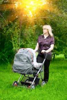 Royalty Free Photo of a Mother With Her Baby in a Carriage 
