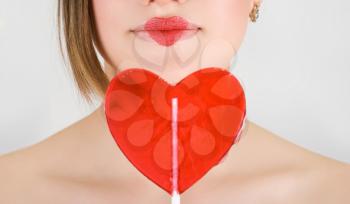 Royalty Free Photo of a Woman Holding a Heart Lollipop 