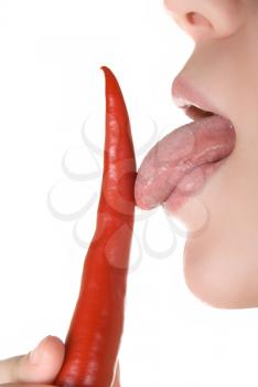 Royalty Free Photo of a Woman Licking a Chili Pepper isolated on white