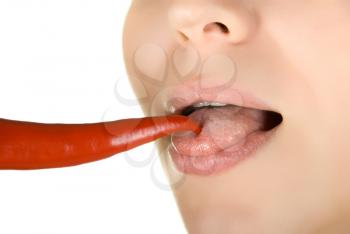 Royalty Free Photo of a Woman Licking a Chili Pepper