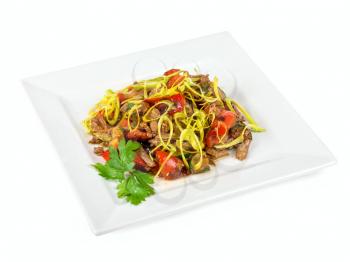 spicy salad of grilled beef with pepper, marinated cucumbers, onion, apple and champignons