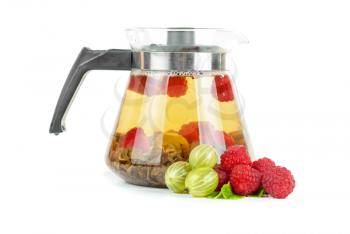 Teapot with fruit tea and berries on a white background