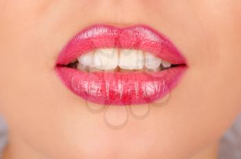 Close up of a young woman's glossy lips