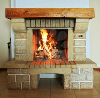 Fireplace with wood and fire closeup