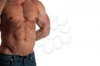 Muscular male torso of bodybuilder at jeans on white background