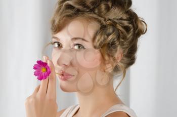 beauty woman closeup portrait with flower over grey background