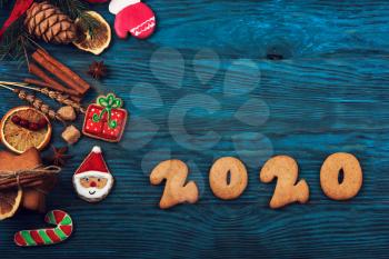 Gingerbreads cookies for New 2020 Year on wooden background, xmas theme