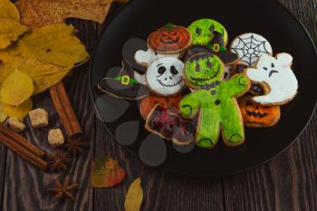 Delicious ginger cookies for Halloween on wooden table