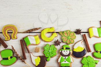 Gingerbreads for Patrick's day and on wooden background