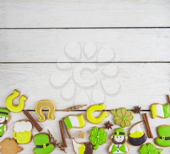 Gingerbreads cookies for Patrick's day on white wooden background