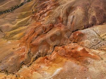 Aerial drone shot of colorful eroded landform of Altai mountains with yellow, brown and red colors.