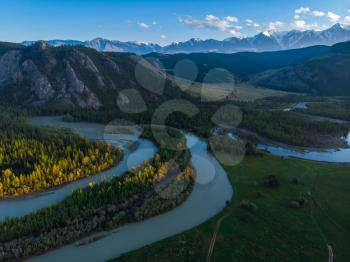 Kurai steppe and Chuya river on North-Chui ridge mountains background. Altai mountains, Russia. Aerial drone panoramic picture.