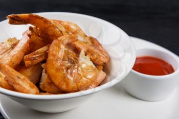 Fried shrimps with tomato sauce on plate
