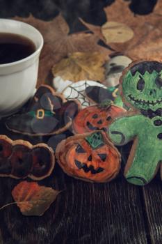 Ginger biscuits for Halloween holiday on wooden table with copy space