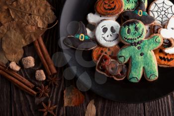 Ginger biscuits for Halloween holiday on wooden table with copy space