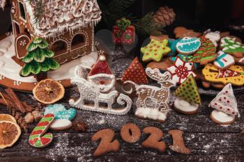 New year 2021, xmas and christmas theme: holiday gingerbreads on wooden background