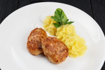 Chicken meat cutlet with mashed potatoes on white plate