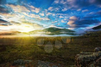 Sunrise in Altai mountains nature reserve. The beginning of autumn, September