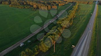 Aerial view of road in summer at sunset. Landscape with road and green grass