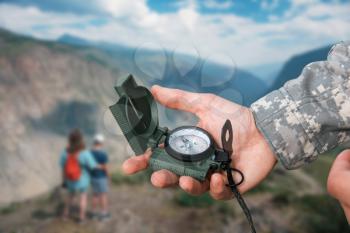 Man with compass in hand n Altai mountains. Travel concept.