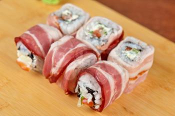 Japanese cuisine - sushi roll with bacon