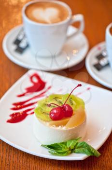 tasty fruit dessert with cherry and kiwi with coffee