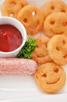 sausages with smiling potatoes and tomato sauce