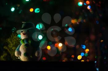 New year bokeh background with snowman
