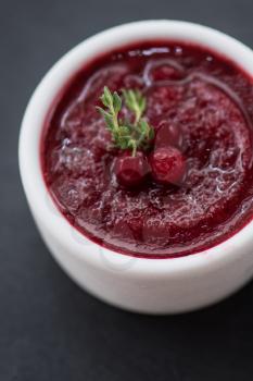 Refreshing cranberry sorbet at white bowl
