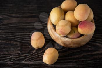 orange fresh apricots on a wooden background