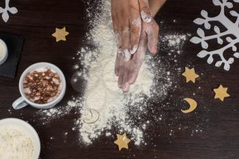 ready for dough by hands on wooden table background