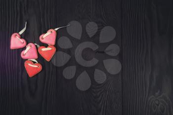 Gingerbreads for Valentines Day or wedding theme on black wooden background