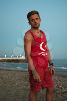 Young man at the evening sea, on the beach at Alania, Turkey