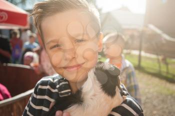 Portrait of happy smiling boy with cavy. Sunny day.