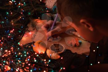 Boy writes a letter to Santa, cristmas background
