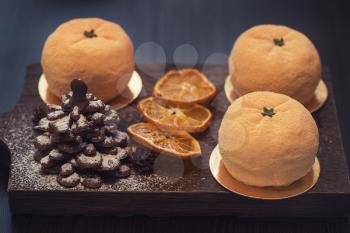 Tasty dessert as orange fruit with chocolate fir-tree