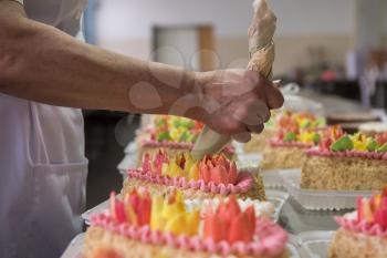 Manual cakes production on factory