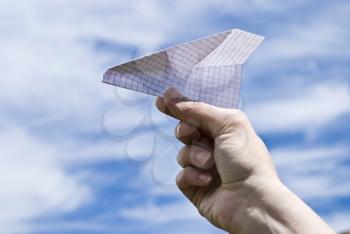 Royalty Free Photo of a Hand Holding a Paper Airplane