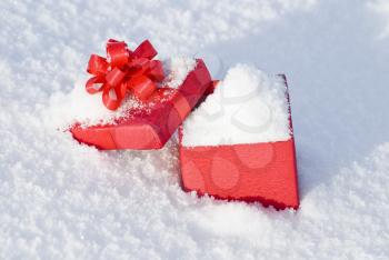 Royalty Free Photo of a Red Gift Box on Snow