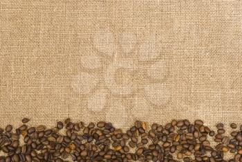 Royalty Free Photo of a Coffee Bean and Sackcloth Background