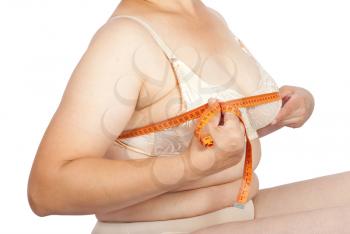 Fat woman measuring breast