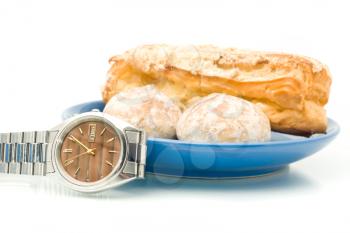 Break - Watch near the plate with delicious pastry